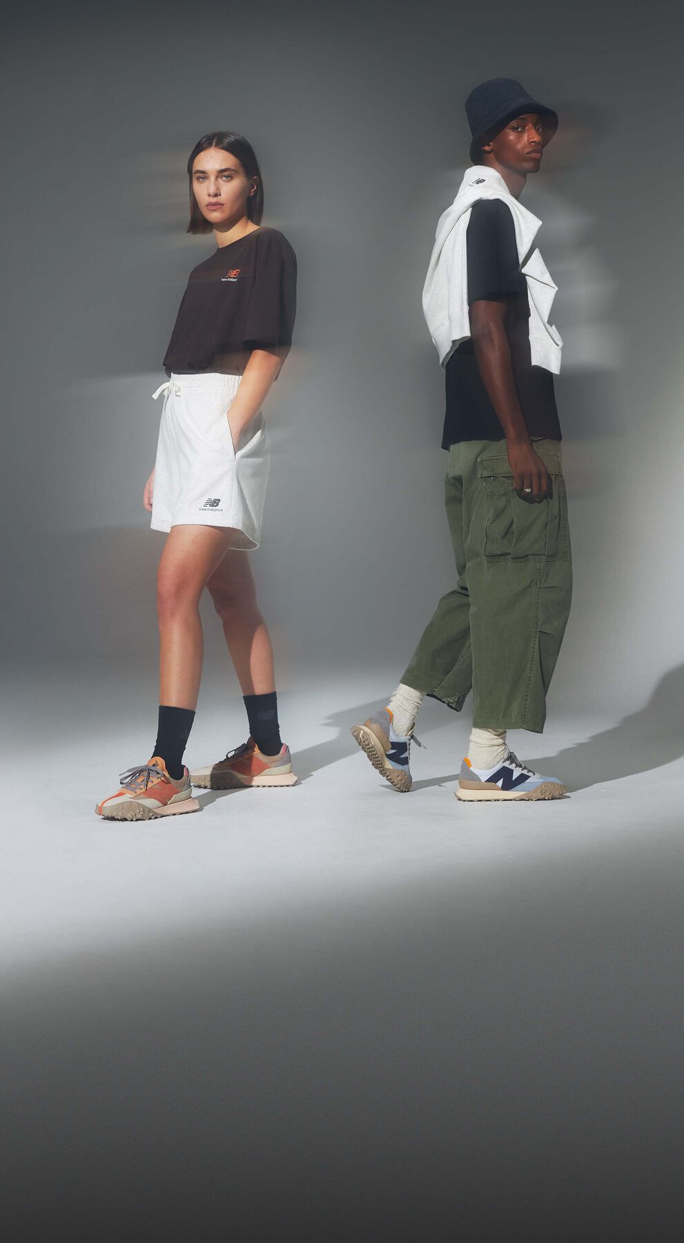Model wearing uni-ssentials sweatpants and hoodie and orange XC-72 shoes. 