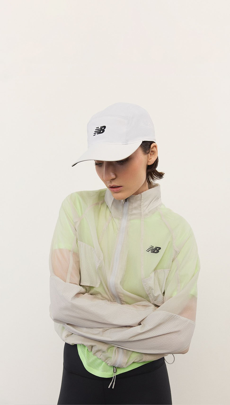 A woman standing in front of a white wall.